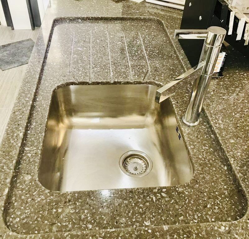 A sink on a counter with tap.